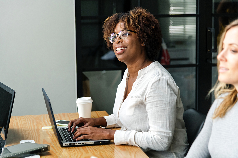 Two women in an office at computers